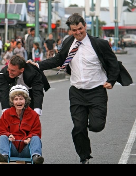 Concert compÃ¨re Rob Harte (running on the right) will have a colourful presence on stage even if it is less energetic than this role in the Dargaville Centennial Trolley Derby when he was pictured with team mates Wayne McKean and Gina Wadsworth.